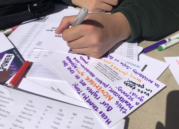 An Advocacy in Action member writing postcards to residents in Texas, encouraging them to vote during the 2024 election.